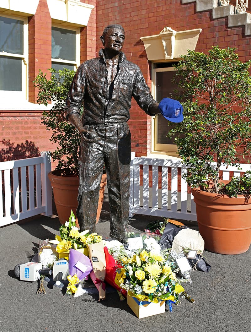 Flowers are placed at the foot of a statue of former Australia cricket captain Richie Benaud at the Sydney Cricket Ground. &mdash; AP
