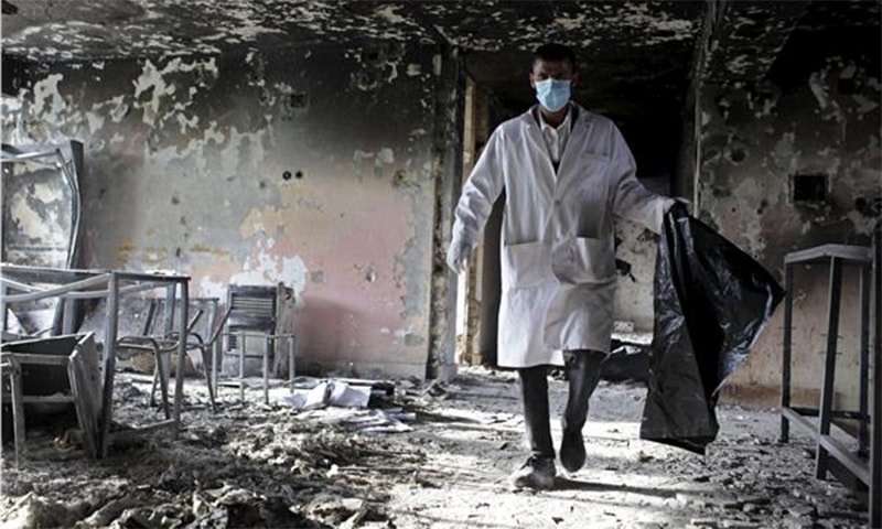 An Afghan official investigates inside of court a day after a Taliban attack in Mazar-i-Sharif ─ Reuters