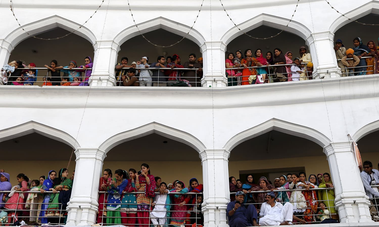 Sikh devotees watch the Baisakhi festival at Panja Sahib shrine. — Reuters