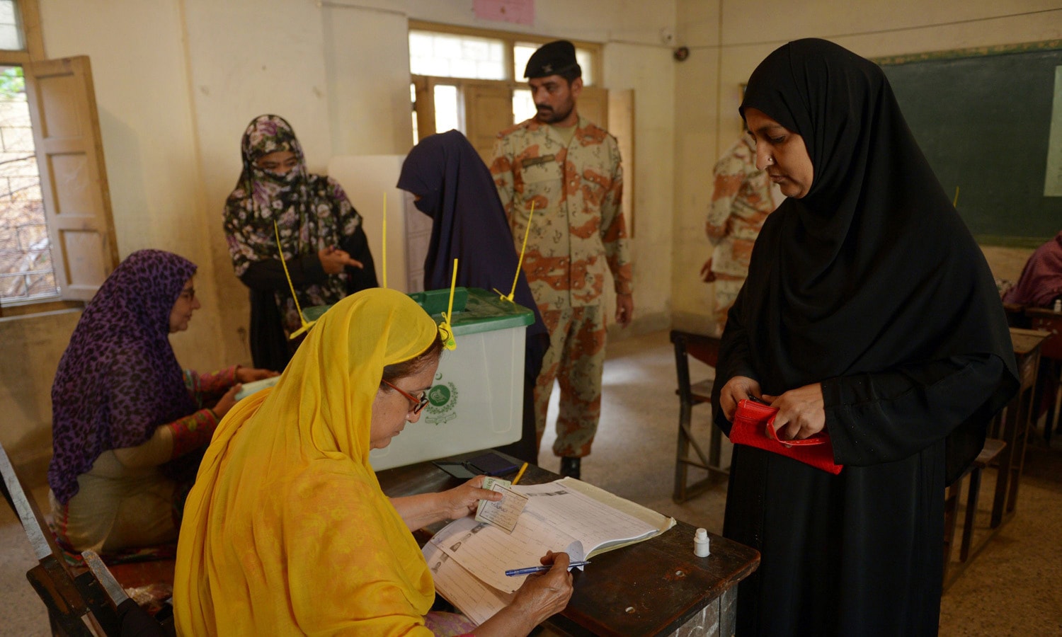 Voters cast their ballots at a polling station during a by-election in Karachi. &mdash; AFP