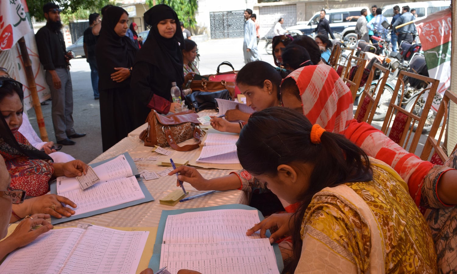 Polling agents at work outside a polling station in NA-246. Photo by Zoya Anwer