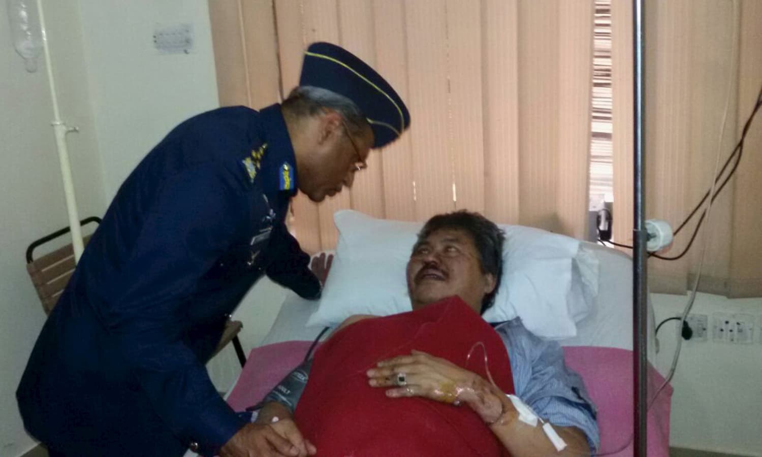 Air Chief Marshal Sohail Aman, Chief of the Air Staff, Pakistan Air Force, enquires Malaysian Ambassador Hasrul Sani Mujtabar about his health at the CMH hospital in Gilgit. &mdash; Reuters