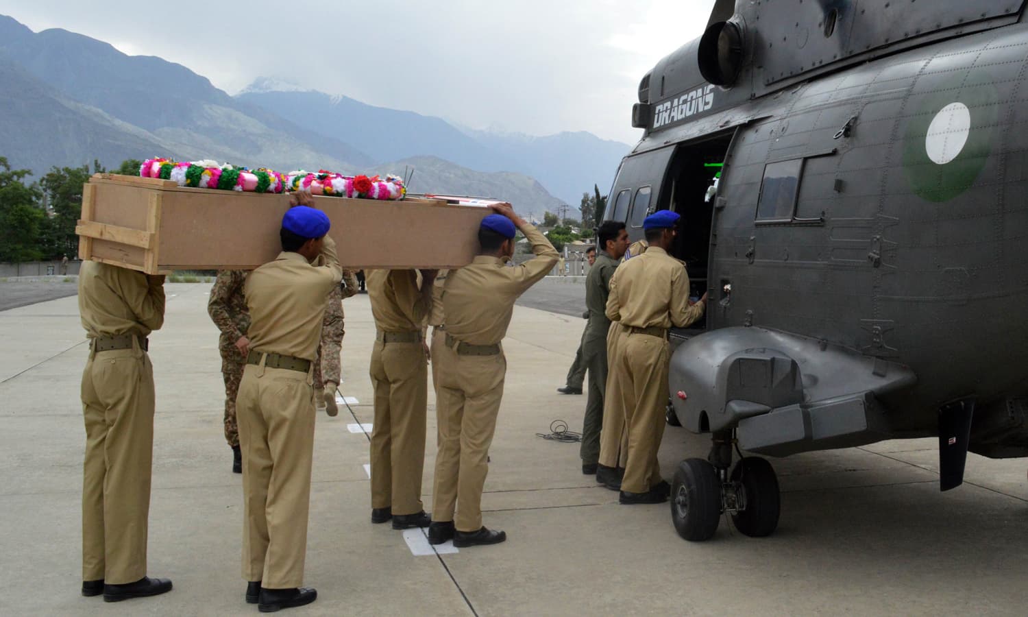 Soldiers load the coffin of the Norwegian ambassador Leif H. Larsen into an army helicopter in Gilgit. &mdash; AFP