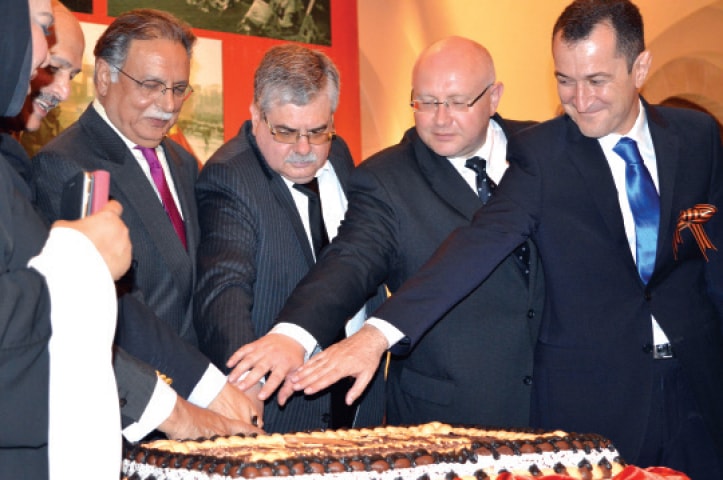 Russian ambassador Alexey Dedov, Information Minister Pervaiz Rashid and other guests cut a cake during a ceremony held to commemorate the 70th anniversary of the end of World War II.
