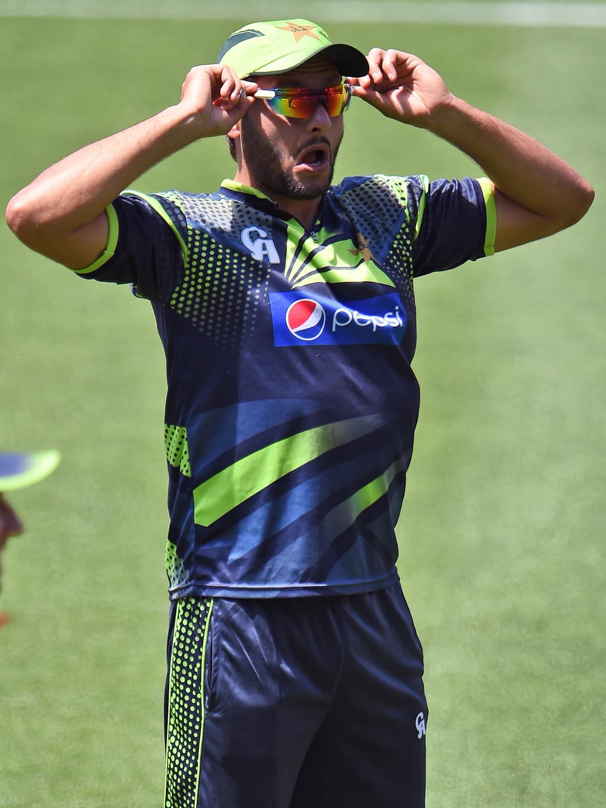 Shahid Afridi adjusts his sunglasses during a training session. —AFP