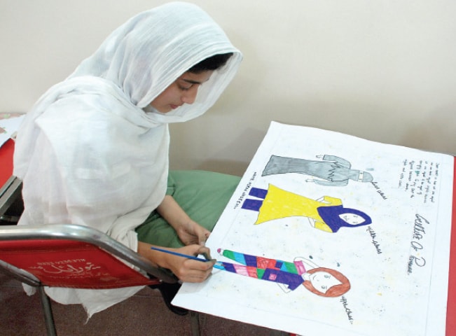 A student works on a poster at a painting and calligraphy competition arranged by the Gandhara Hindko Academy in Peshawar on Thursday. &mdash; Dawn