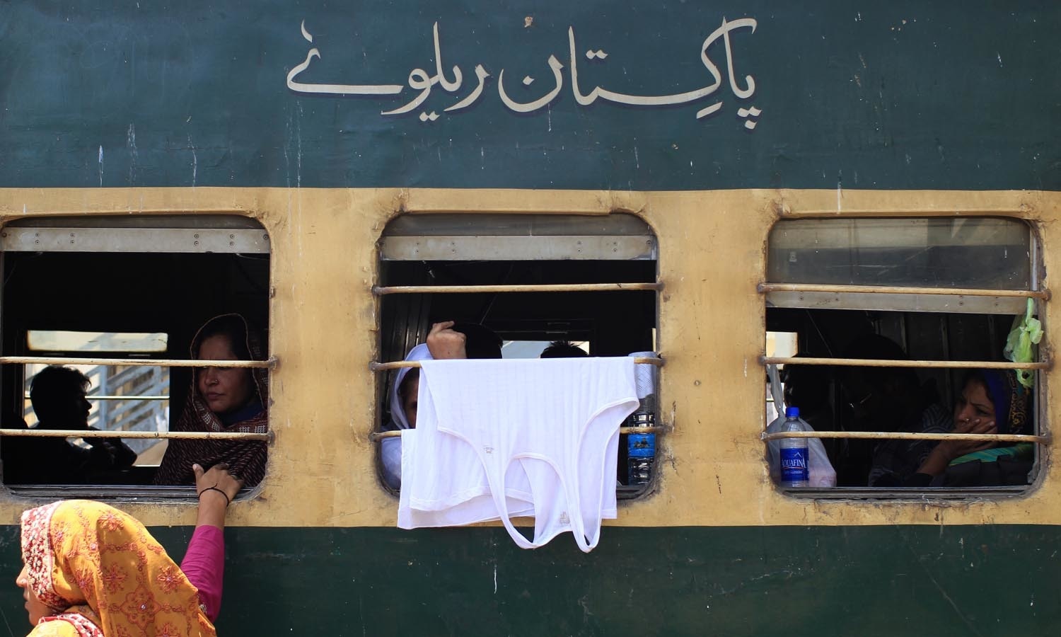 A woman makes a wise use of window grill.