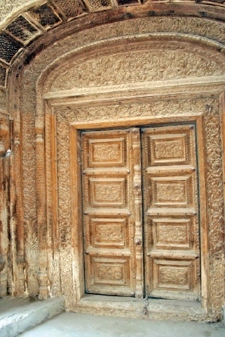 The carved wooden door of a house where the family of late patwari Chauhdry Mehboob Hussain lives now.