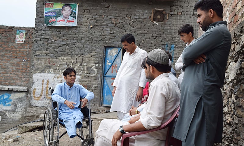 Newly-elected councillor Sher Ali in discussion with locals.  —Photo by author