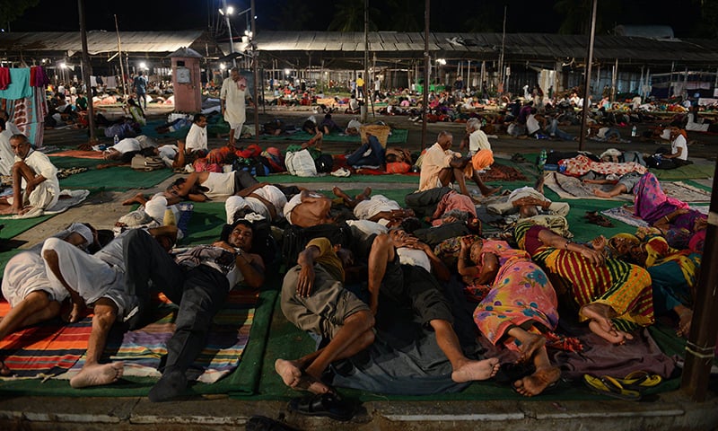 Indian participants rest prior to receiving fish medicine from members of the Bathini Goud family at the exhibition grounds in Hyderabad