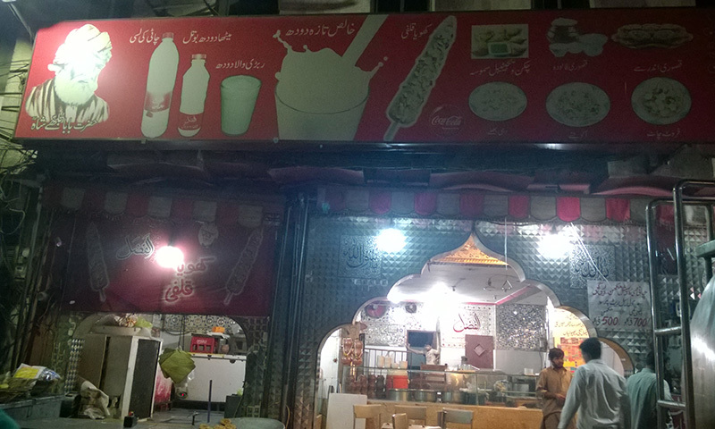 Baba Bulleh Shah graces the Al-Fazal board instead of the shop's name â Photo by the author