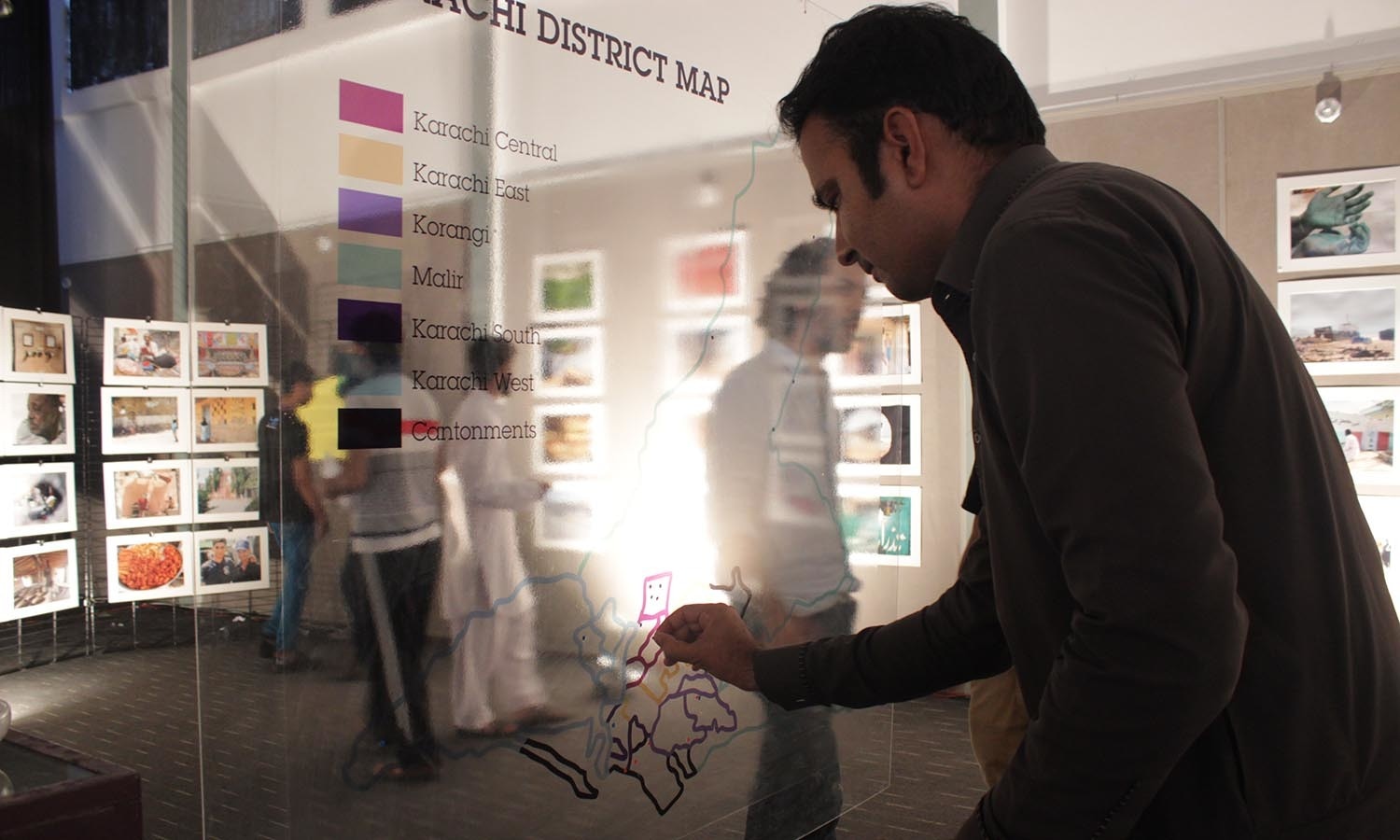 An attendee placing stickers according to the districts. — Photo by Manal Khan