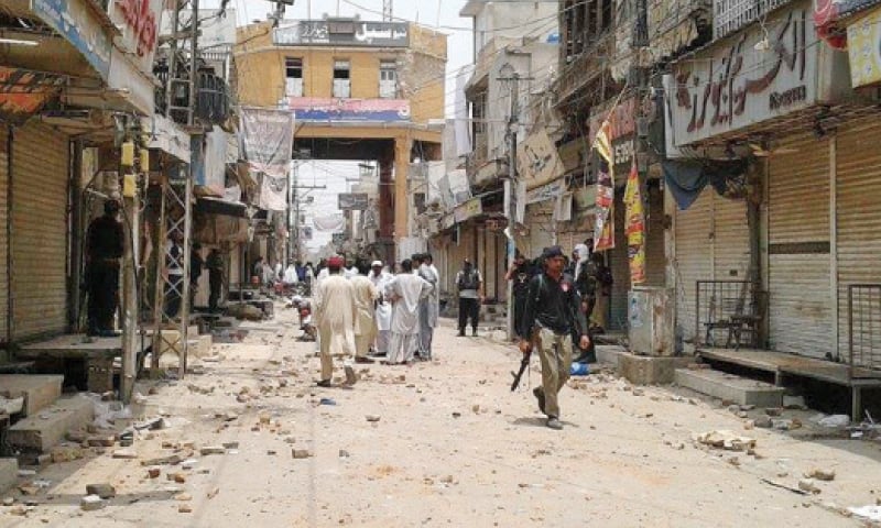 A policeman walks through the Gomal Trade Market closed after a clash in Dera Ismail Khan on Wednesday. — Dawn