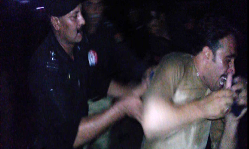 A policeman arrests a protester during violent demonstratioins against load shedding.—Ali Akbar