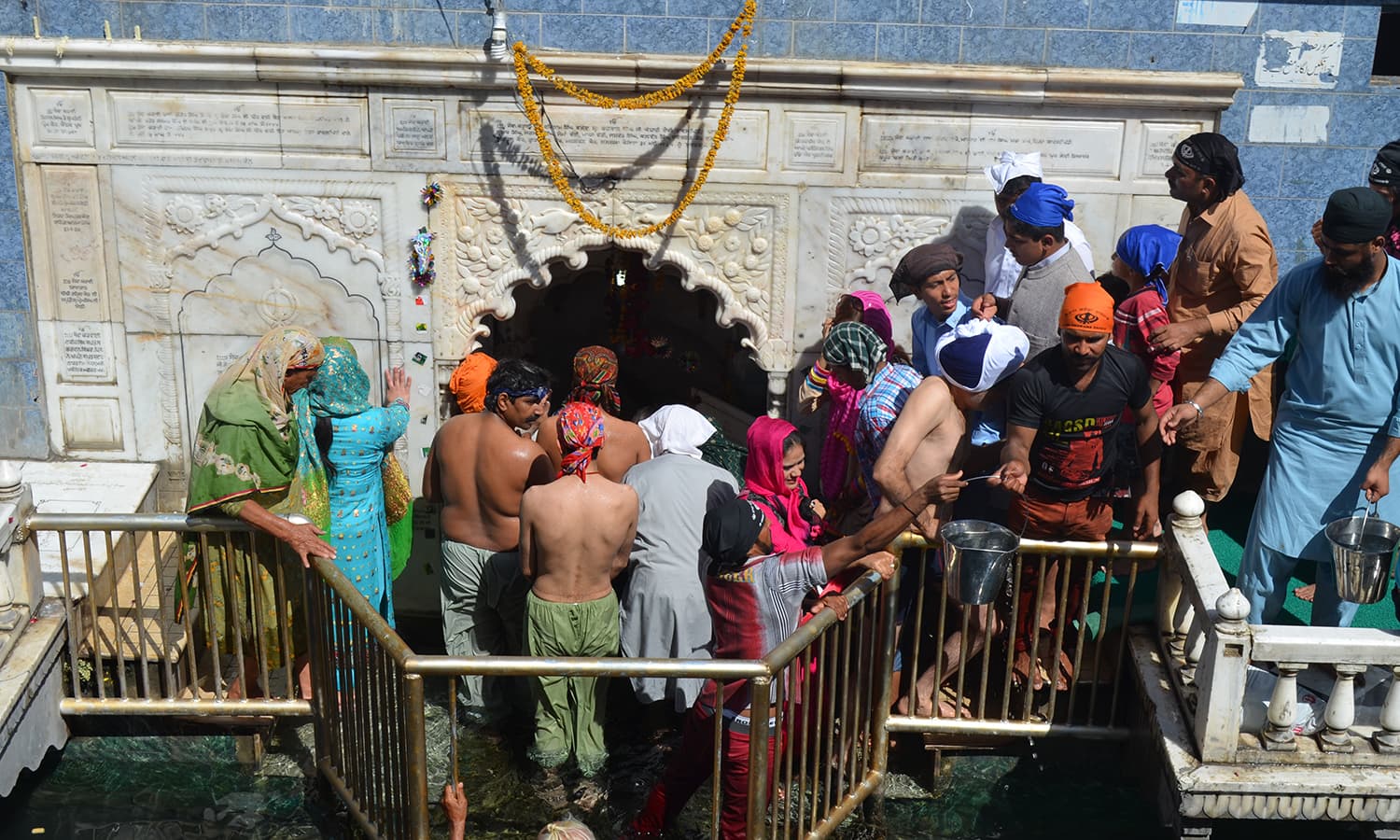 Pilgrims flock around the symbolic Punja.