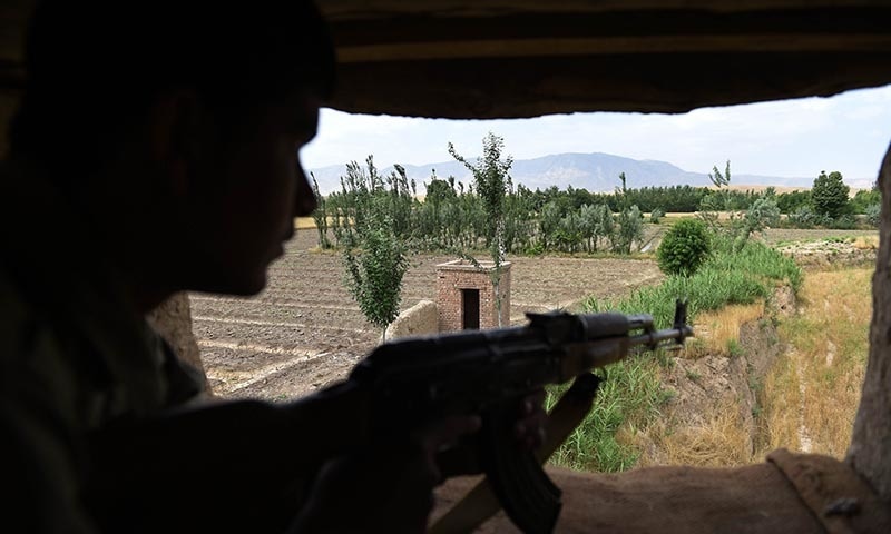 ALP member keeps watch in Kasab village in Kunduz. -AFP