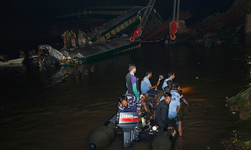 Pakistani rescue workers search for victims after a train carrying soldiers and military hardware fell into a canal following the partial collapse of a bridge in Wazirabad in the Punjab province on July 2, 2015. -AFP