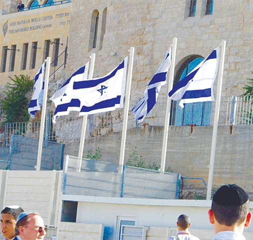 Israeli flags fly atop the Jewish Quarters in Al-Quds in Jerusalem