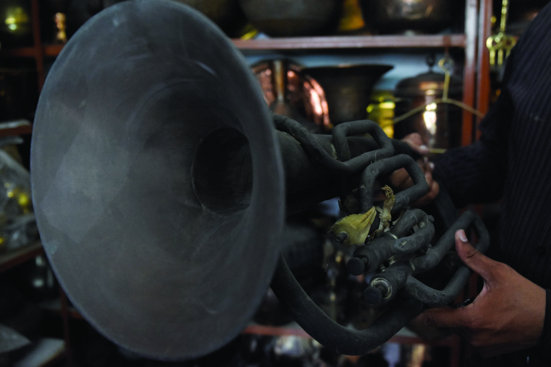 An unpolished tuba — a brass musical instrument popularly used by military bands.