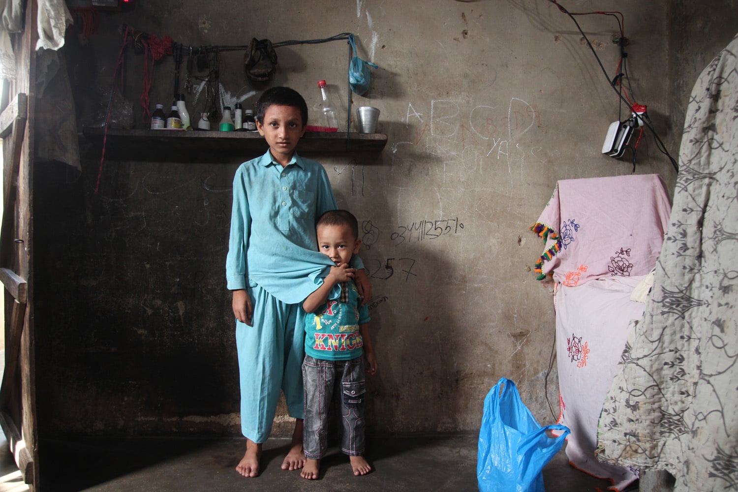 Yaseen, who studies at TCF, poses with his younger brother.