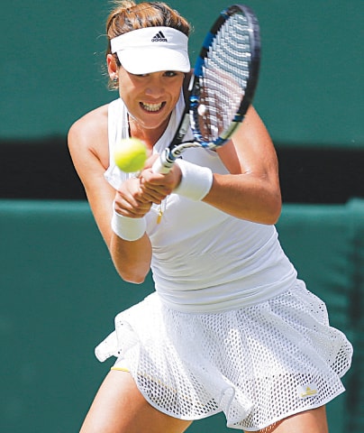 Garbine Muguruza hits a return to Serena Williams during the Wimbledon final.&mdash;AP
