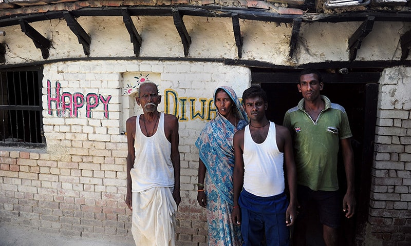 Ram Janam Mauriya (L), who is struggling to prove to authorities that he is still alive after being declared dead by his younger brother, poses for a photograph alongside family members in the Azamgarh district of the state of Uttar Pradesh. &mdash;AFP