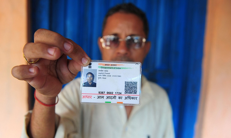 Farmer Jagdish Prasad Gupta poses for a photograph with his identity card in the Mau district of the state of Uttar Pradesh. &mdash;AFP