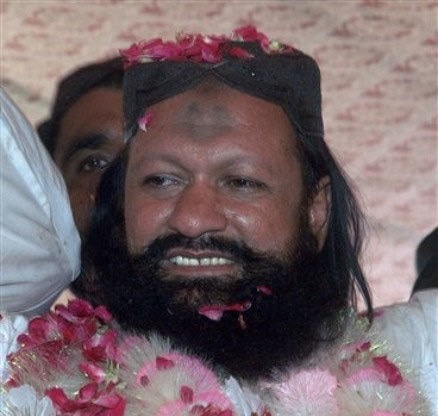 In this photo taken on July 15, 2011, Malik Ishaq is greeted by supporters with rose-petals upon his arrival in hometown after his release from jail, in Rahim Yar Khan. – AP/File