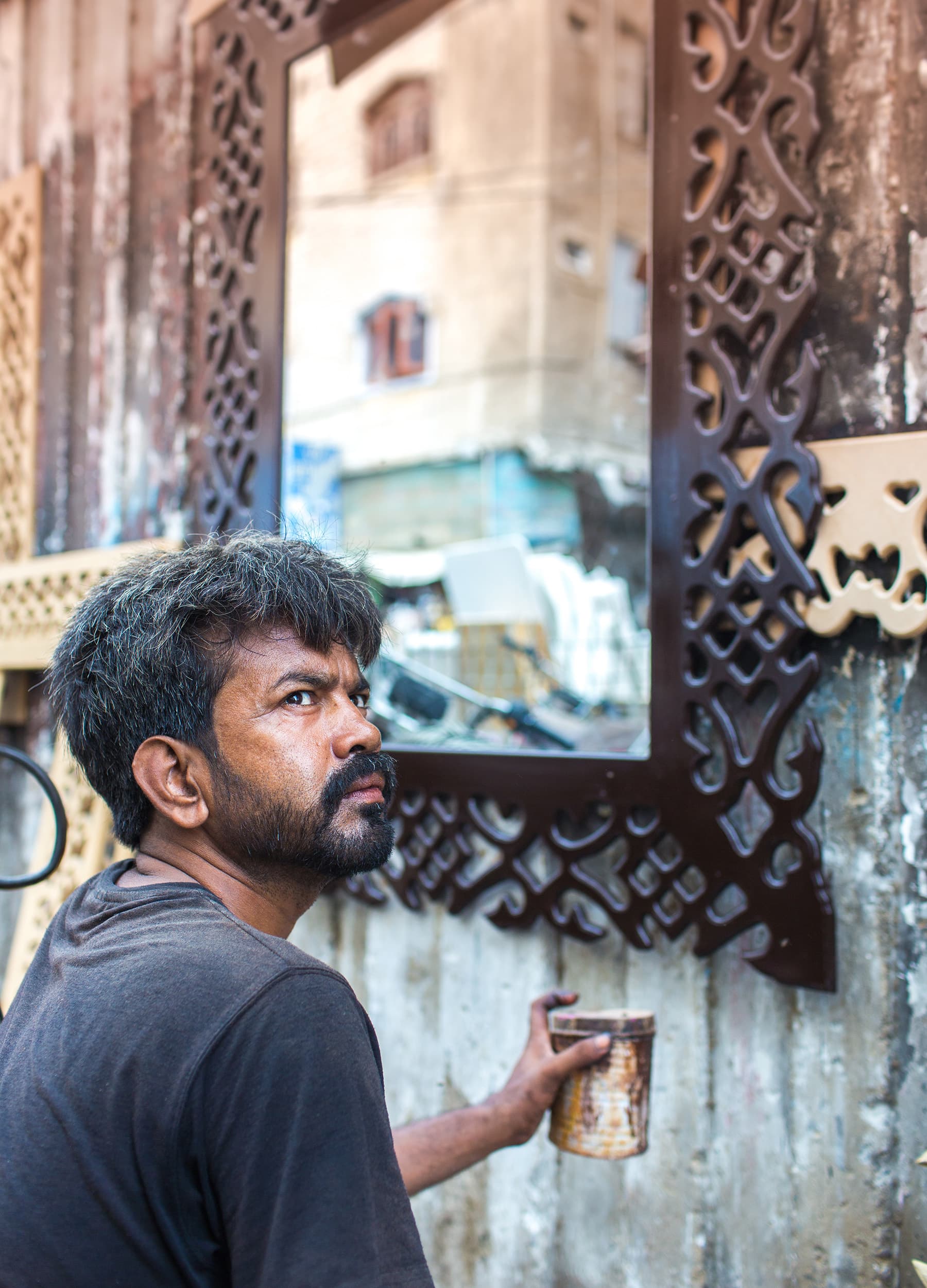 Muhammad Aqeel while working on a wooden framework for a mirror.