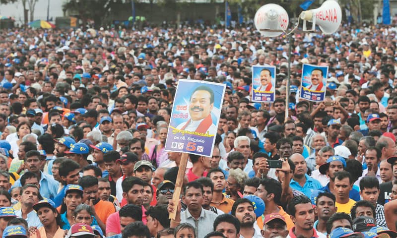 SUPPORTERS listen to Sri Lanka’s former president and parliamentary candidate Mahinda Rajapaksa at an election campaign rally in Anuradhapura on July 17.—AP