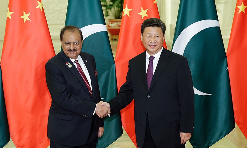 China's President Xi Jinping (R) shakes hands with Pakistan's President Mamnoon Hussain (L) before their meeting at the Great Hall of the People in Beijing on September 2, 2015.  —AFP