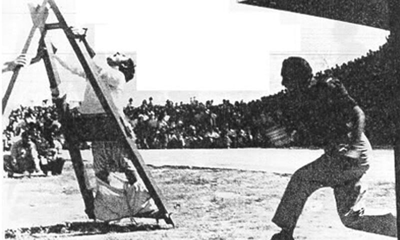 A policeman flogs an anti-Zia political activist in Lahore in 1979.