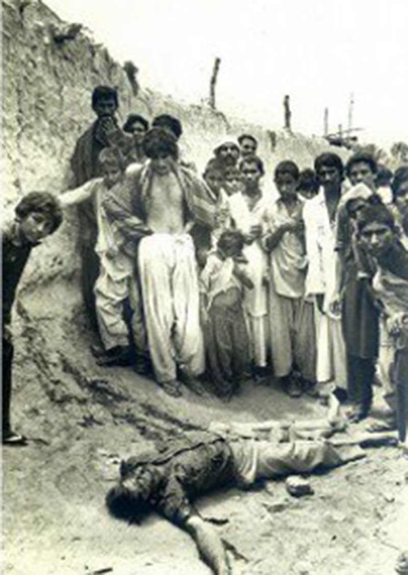 People gather around the body of an MRD activist in a village near Dadu (September, 1983).