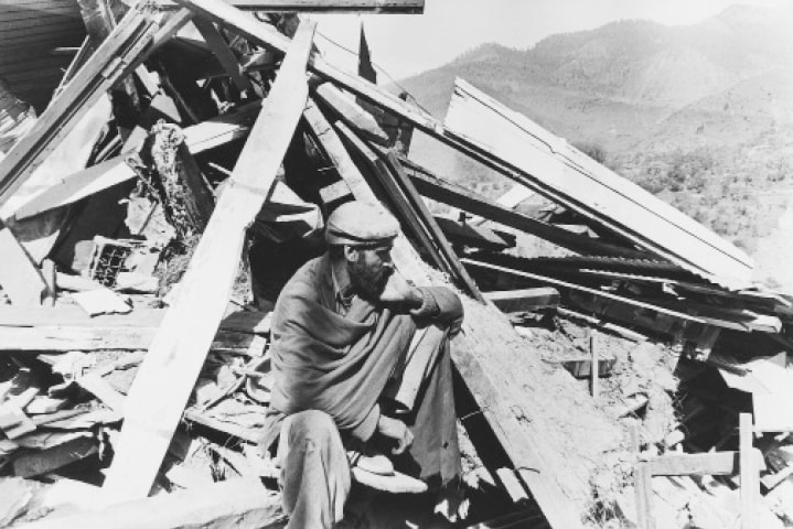 A MAN sits on the rubble of his destroyed home in the Koutch e Syeda area of Azad Kashmir.—White Star