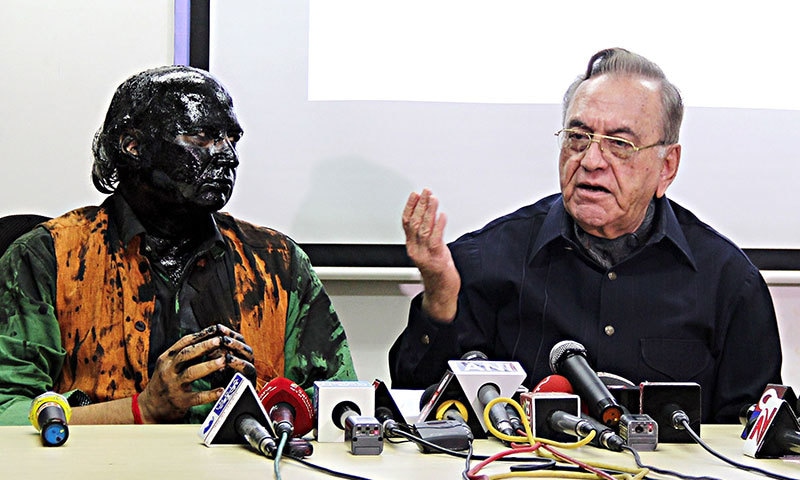 Sudheendra Kulkarni looks on as former Pakistani foreign minister Khurshid Mahmud Kasuri speaks to media in Mumbai ─ AFP