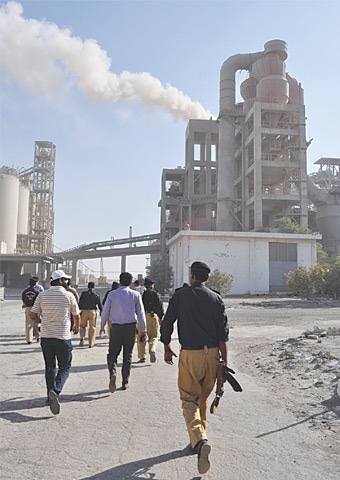 POLICE along with EPA officials visit the cement factory to seal it off on Tuesday.—Dawn