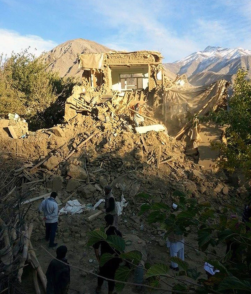 Afghan residents examine a damaged house after an earthquake in Raman Kheel village in the Panjshir valley on October 26, 2015.&mdash; AFP