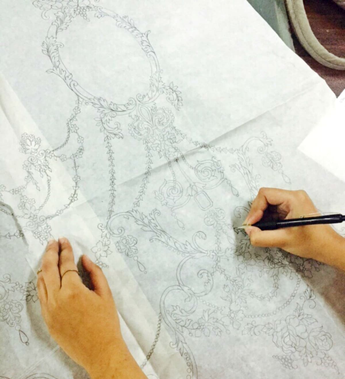 A designer at Maria B works on the embroidery sketch - Photo courtesy Maria B