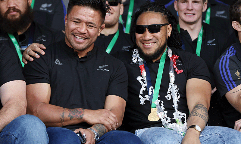 All Blacks Keven Mealamu (L) and Ma'a Nonu (R) smile at a parade and official welcome for the rugby team in Auckland. — AFP