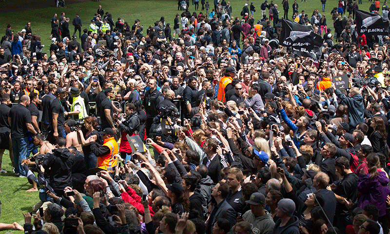 New Zealand players make their way to the stage at the welcome home ceremony for the All Blacks in Auckland. — AP