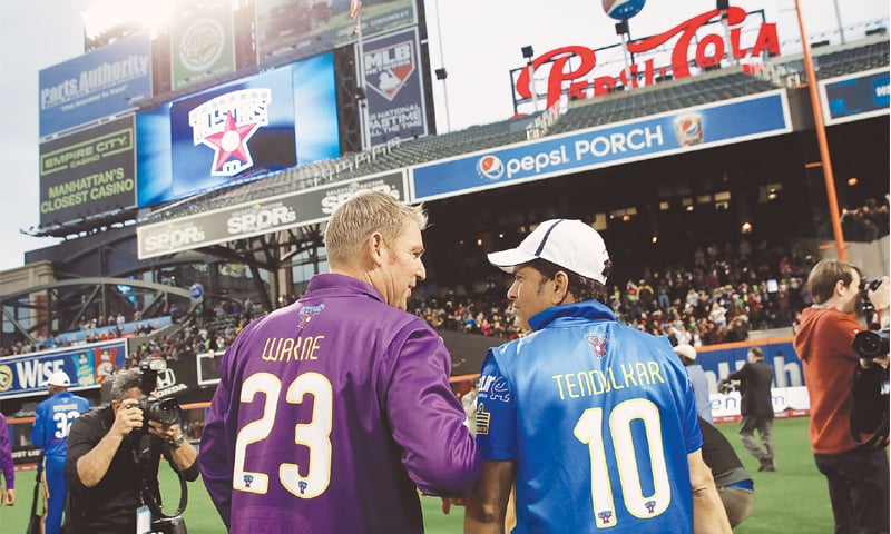 Shane Warne and Sachin Tendulkar take a lap around the Citi Field after the first game of the All-Stars series.—AP