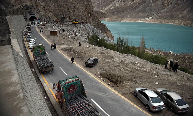 Commuters wait to travel through a newly built tunnel in Gojal Valley. — AFP