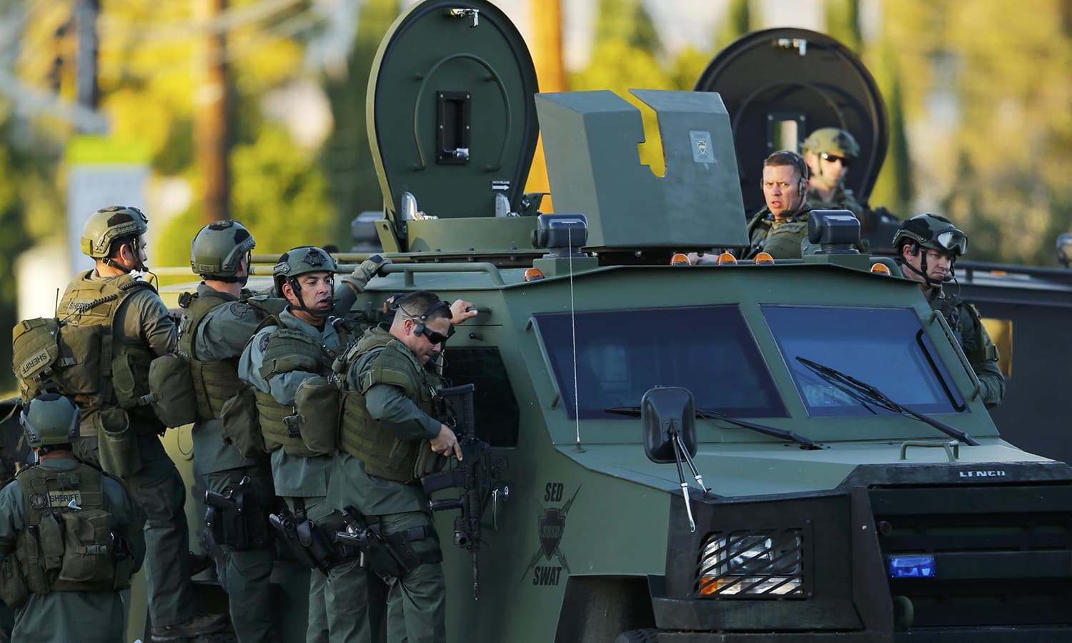 Police officers conduct a manhunt after the mass shooting in San Bernardino. ─ Reuters