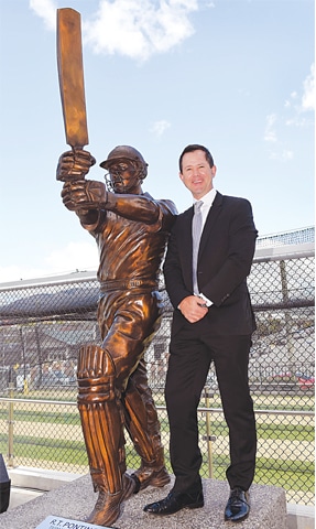 Legendary Australian cricketer Ricky Ponting poses alongside his statue. — AFP