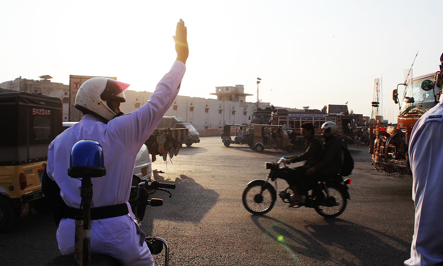 Traffic policeman Ahmed motions for traffic to stop. ─ Photo by author