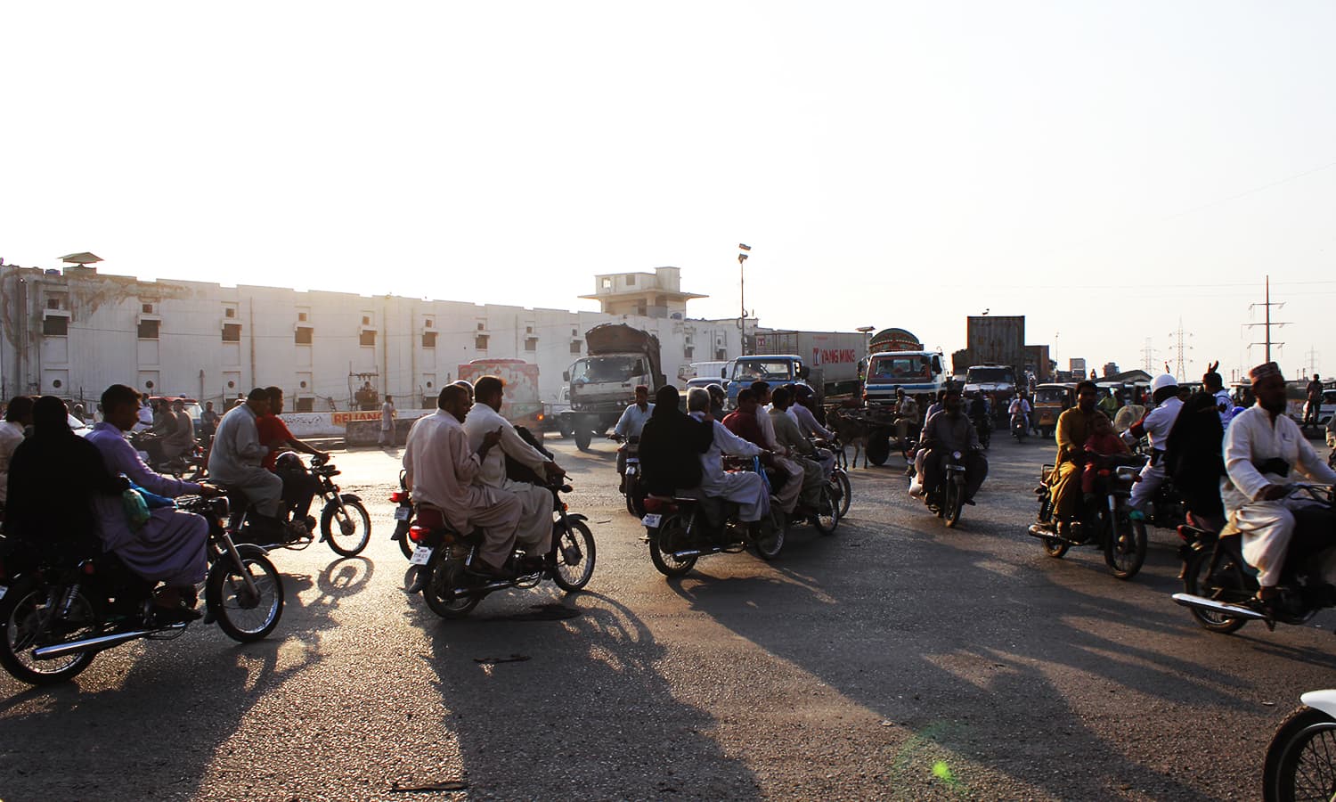 When the traffic signal turns green, motorcyclists surge ahead impatiently. ─ Photo by author