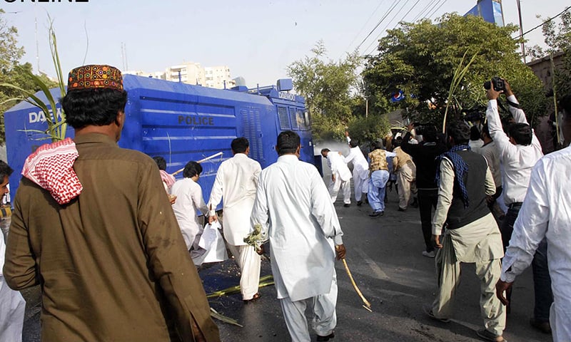 Growers attacking police water cannon with sugarcanes as they are stopped from going towards CM House. &mdash;Online