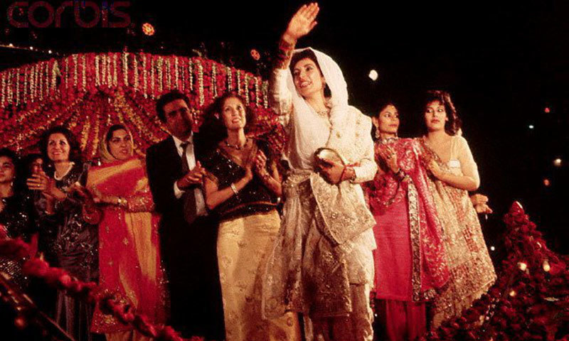 Benazir Bhutto waves to the crowd from the stage at her wedding celebrations held in Karachi’s Lyari area (1987).