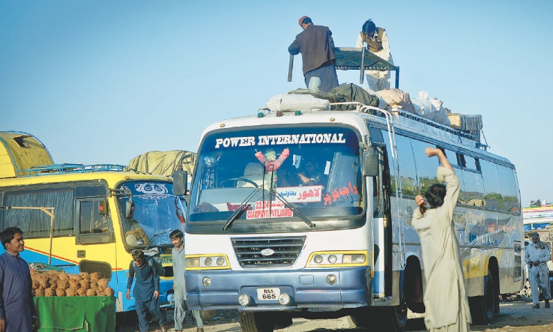 All kinds of luggage on the roof rack of a coach.