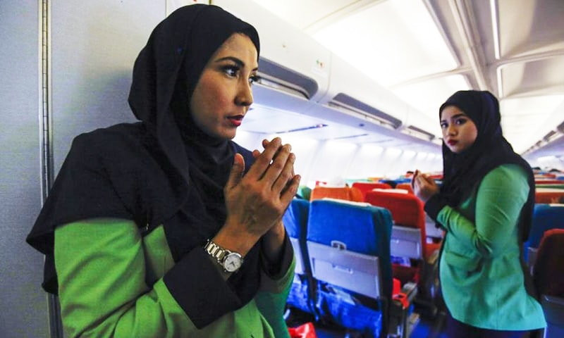 Rayani Air flight crew prays before departure at Kuala Lumpur International Airport 2 in Sepang, Malaysia. — AP